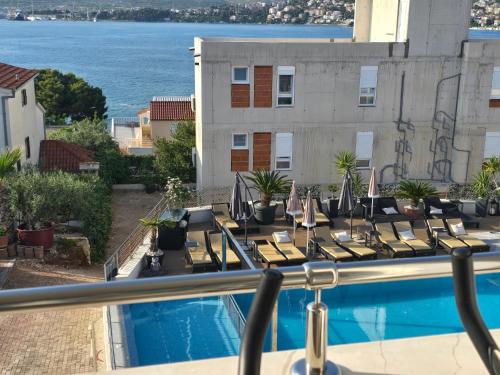 a view from the balcony of a hotel with a swimming pool at Luxury Apartments Silva with sea view in Trogir