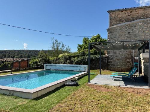une piscine dans l'arrière-cour d'une maison dans l'établissement la maison bleue du plot, à Ailhon