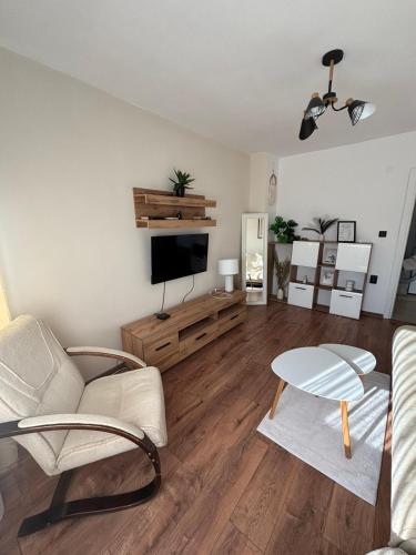 a living room with a couch and a tv at White House Apartments - Boho in Haskovo