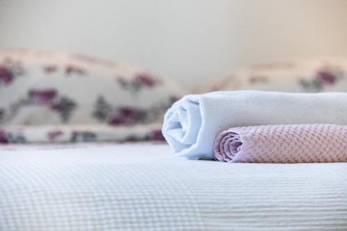 a rolled up towel sitting on top of a bed at Borea Strunjan in Portorož