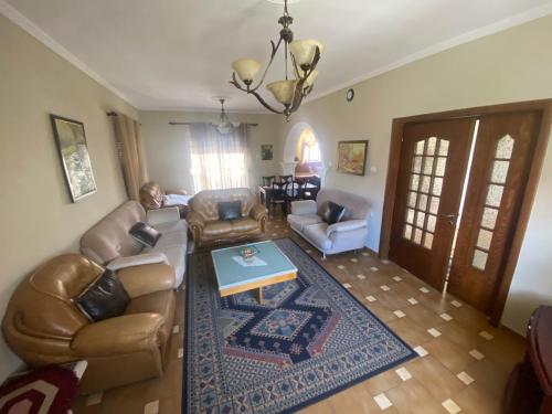 a living room with a couch and a table at Vila Ridvani in Korçë
