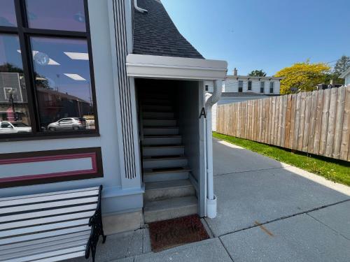 a stairway leading up to a building with a stair case at The Historic Downtown Suite in Sheboygan Falls