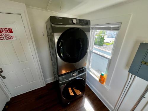 a microwave oven in a kitchen next to a window at The Historic Downtown Suite in Sheboygan Falls