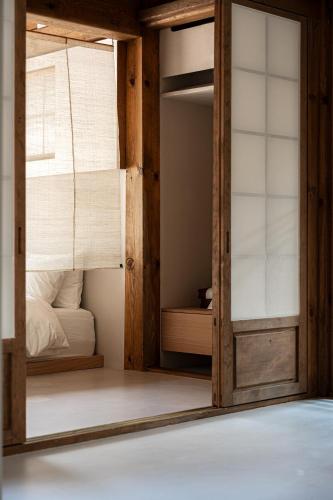 a room with two bunk beds and a window at Hyowudang in Gyeongju