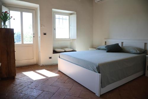 a bedroom with a large bed and a window at Casabella Lake in Castelletto sopra Ticino