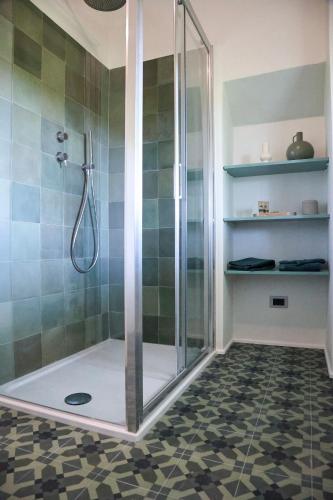 a shower stall in a bathroom with a tiled floor at Casabella Lake in Castelletto sopra Ticino