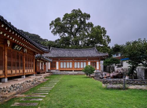 a building with a garden in front of it at Hyowudang in Gyeongju
