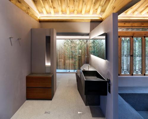 a bathroom with a sink and a wooden ceiling at Hyowudang in Gyeongju
