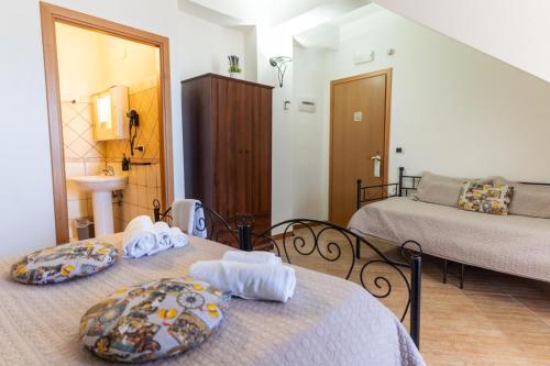 two beds in a small room with a bedroom at Bed and Relax-Il Maniero in Calatabiano