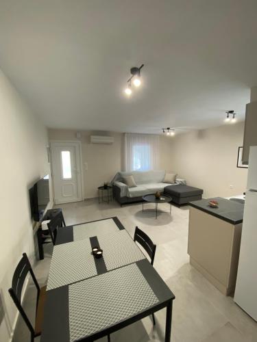 a living room with a table and chairs and a couch at Alion houses in Prinos