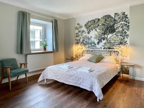 a bedroom with a white bed and a chair at Zielona 5 in Lublin