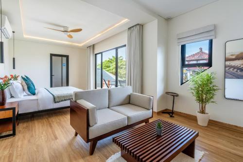 a living room with a couch and a bed at Oasis Residences in Sanur
