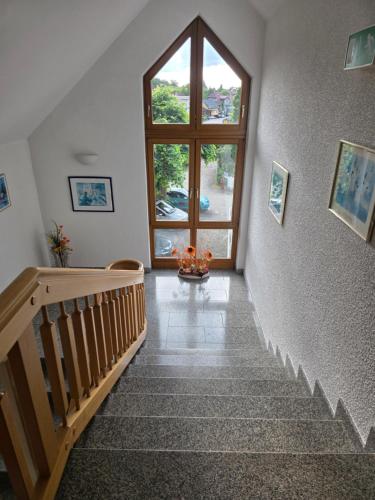 a stairway with a large window and a stair case at Hotel Restaurant Adler Bühlertal in Bühlertal