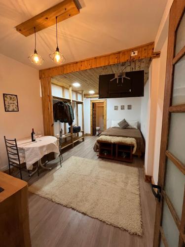 a bedroom with a bed and a table in a room at Pousada Saint Claire in Santo Antônio do Pinhal