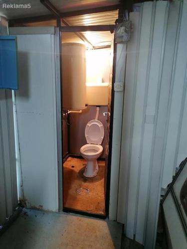 a bathroom with a toilet in a small room at medusa gradiste in Ohrid