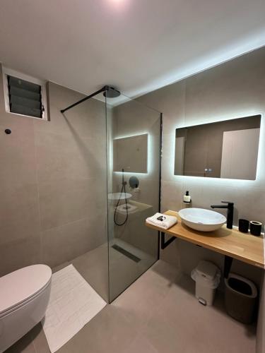 a bathroom with a shower and a toilet and a sink at New Apartment Riverside in Sarandë