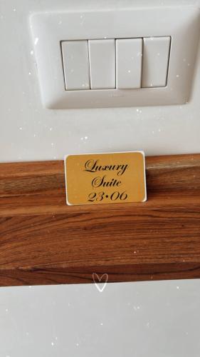 a sign that says charitylierlier on a wooden shelf at Luxury Suite 23 06 in Casamassima