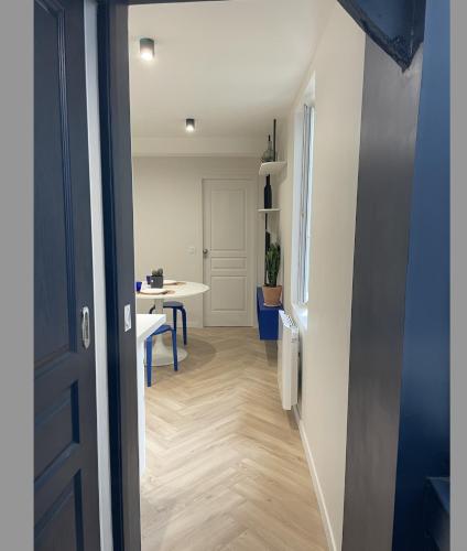 Cette chambre dispose d'un couloir avec une table et une porte. dans l'établissement 2 pièces Pau centre-ville, à Pau