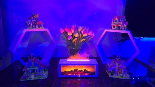 a vase of flowers in a box with a fire in it at TAGAYTAY CONDO STAY BY RL's SUITE in Tagaytay