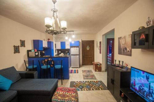 a living room with a couch and a kitchen at Chalet in Sahel Mountain view Diplo in Ras Elhekma