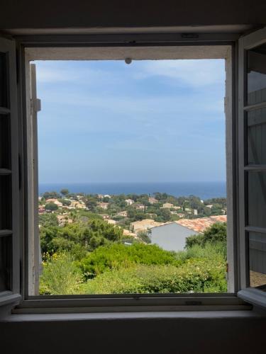 a window with a view of a city at Le Fagneton - Seaview Villa Cote d'Azur in Roquebrune-sur-Argens