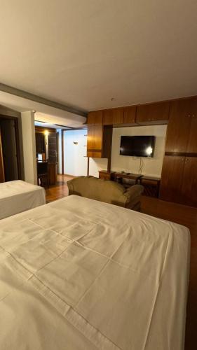 a hotel room with a bed and a couch at KUBITSCHEK - JK APART Hotel in Brasília