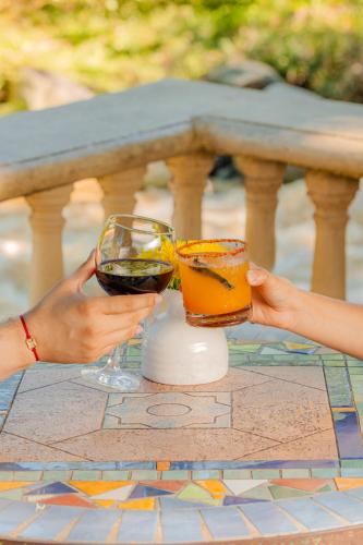 two people holding wine glasses on a table at Hotel Gran Jimenoa in Jarabacoa