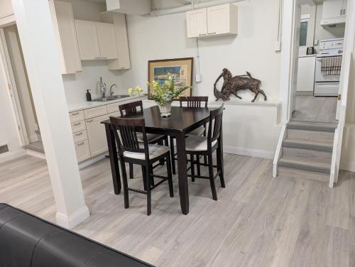 a kitchen and dining room with a table and chairs at Cozy Bachelor Unit in Guelph