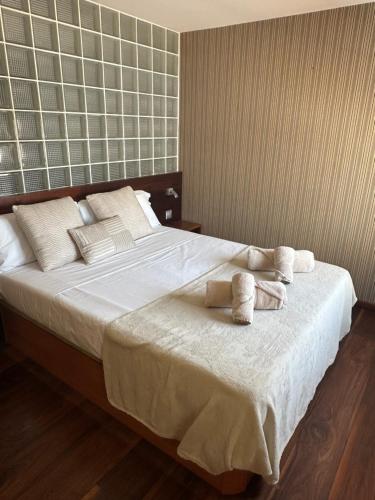 a bedroom with a large bed with towels on it at Apartamento PLAYA PEQUEÑA LUXURY in Benidorm