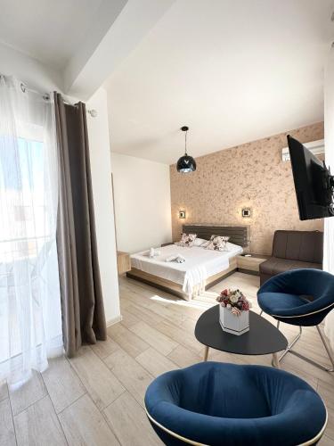a room with a bed and a couch and tables at Apartmens Xhenis Lux in Ulcinj