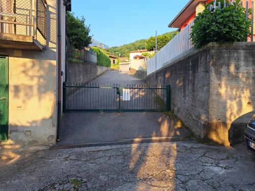 an open gate to a building with a driveway at Il Palazzo apartment with a view of the lake and nature in Calolziocorte