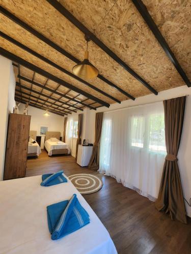 a bedroom with a bed with blue pillows on it at Erdem Ciftligi/ Ephesus Arena in Selçuk