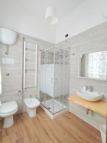 a bathroom with a shower and a toilet and a sink at AlbaNova in Naples