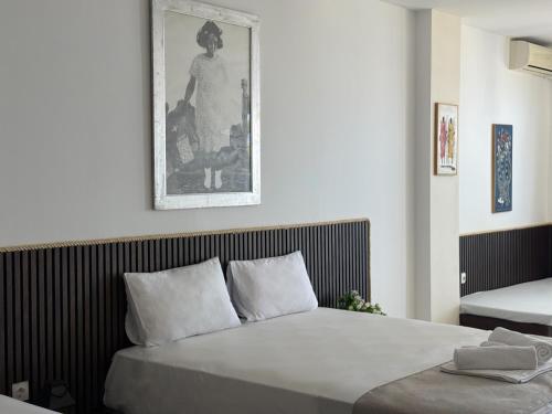 a bedroom with a bed and a picture on the wall at Amelia Seaview Apartments & Studios in Kallithea Halkidikis