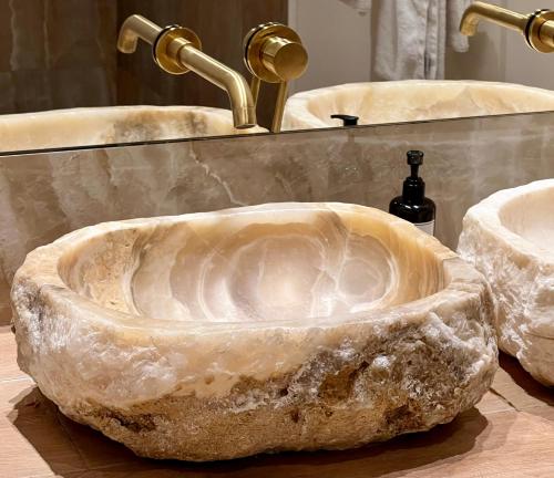 a stone sink in a bathroom with two sinks at Comfy Studios Hotel in Benalmádena