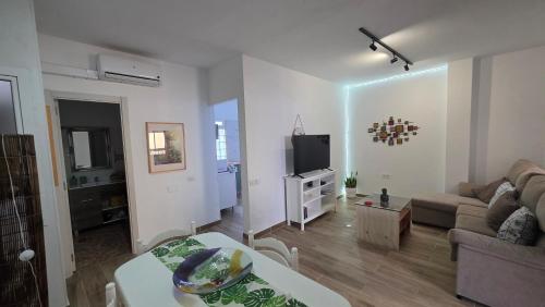 a living room with a couch and a tv at Apartment with terrace in Vecindario
