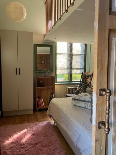 a bedroom with a bed and a staircase in it at Stationshus apartment in Hallstahammar