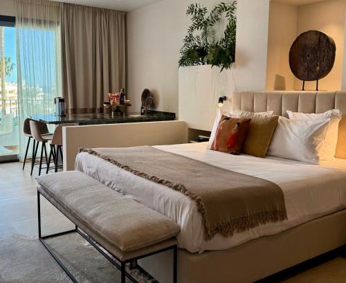 a bedroom with a large bed and a dining room at Comfy Studios Hotel in Benalmádena