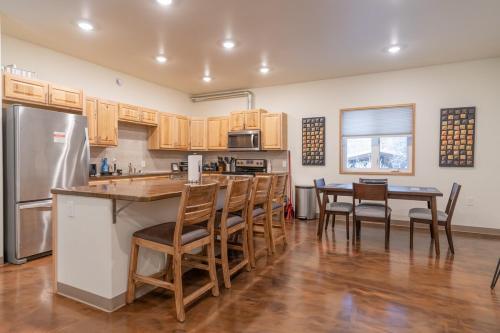 a kitchen with wooden cabinets and a table and chairs at Modern City Suite 2 in Fairbanks