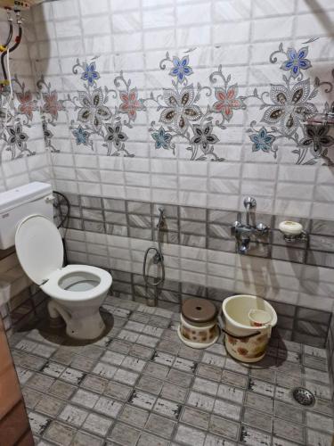 a bathroom with a toilet and a sink at HOTEl momin in Srinagar