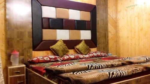 a bed with pillows on it in a room at HOTEl momin in Srinagar