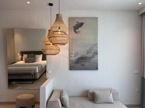 a living room with a bed and a chandelier at Comfy Studios Hotel in Benalmádena