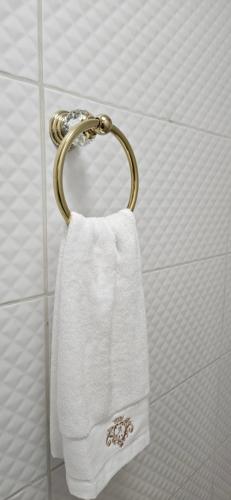 a towel hanging on a towel rack in a bathroom at Vila Skodupė 