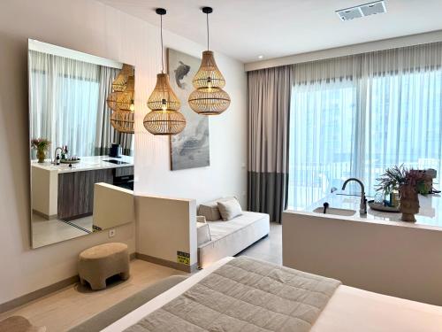 a bedroom with a bed and a living room at Comfy Studios Hotel in Benalmádena