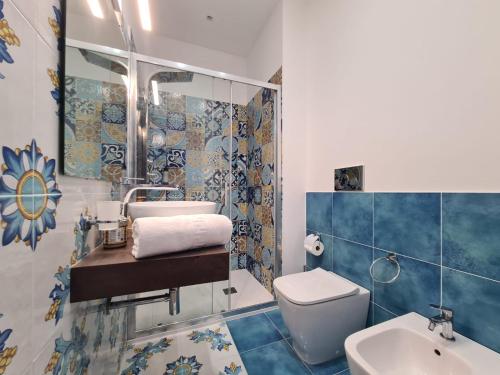a bathroom with a sink and a toilet at B&B testa di Moro in Giarre