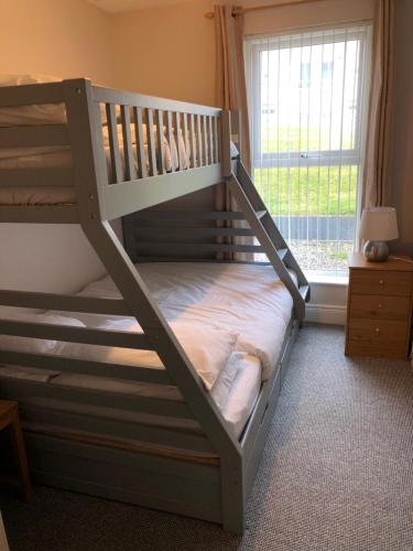 a bunk bed in a room with a window at 46 west strand avenue in Portrush
