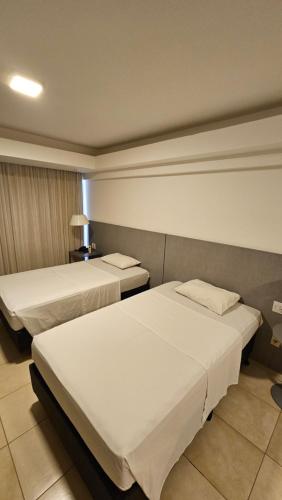 a hotel room with two beds in a room at Flat 01 Celita Franca Business in Feira de Santana