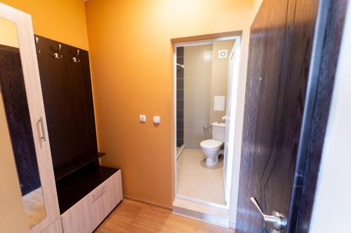 a bathroom with a toilet and a shower in it at GGeorgi Sarafovo in Burgas City