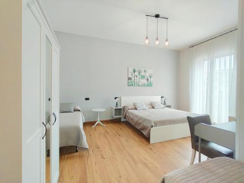 a bedroom with a bed and a desk and a table at AlbaNova in Naples