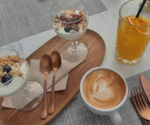 a table with a tray of breakfast food and a cup of coffee at Comfy Studios Hotel in Benalmádena